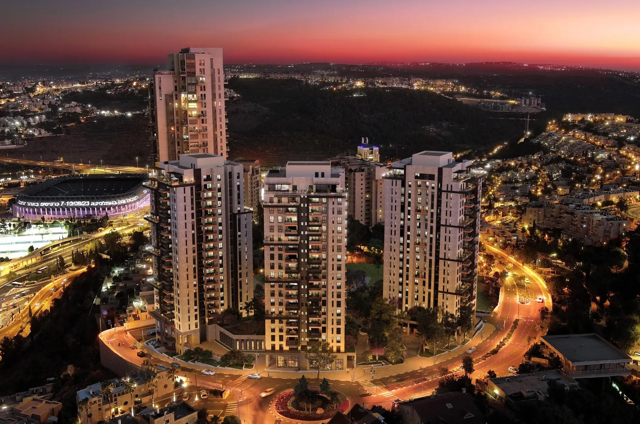 Aerial night view of the Prime Jerusalem towers next to Teddy Stadium and Begin Boulevard